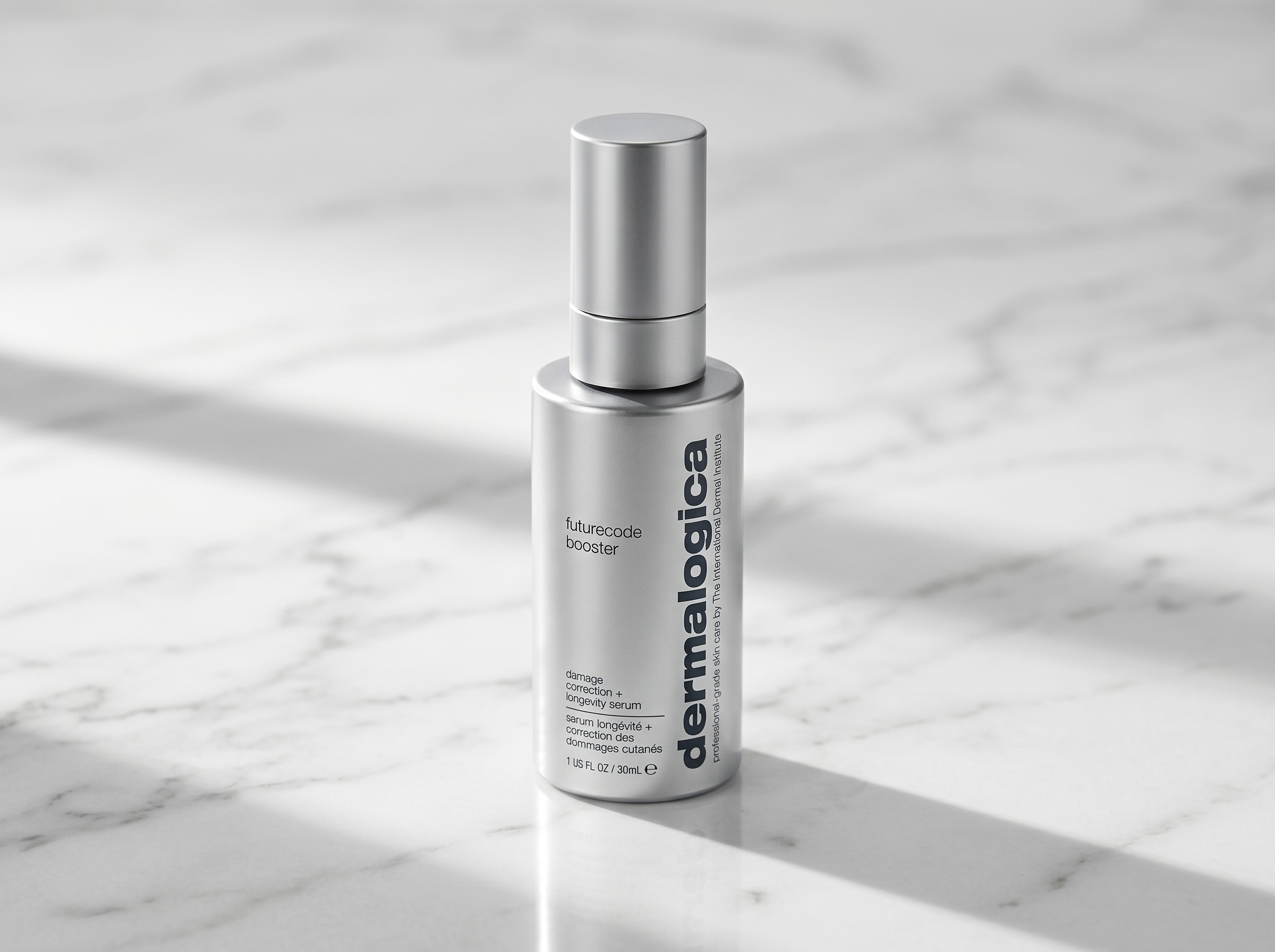Dermalogica FutureCode Booster serum bottle on a white marble surface with soft directional lighting