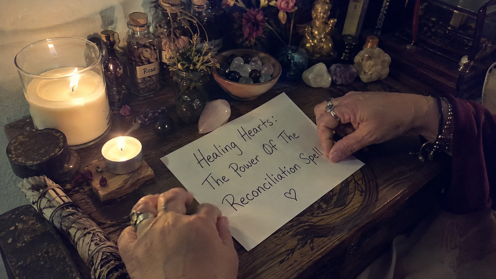 A glowing candle arranged with crystals and herbs symbolizing the reconciliation spell for healing hearts and restoring love