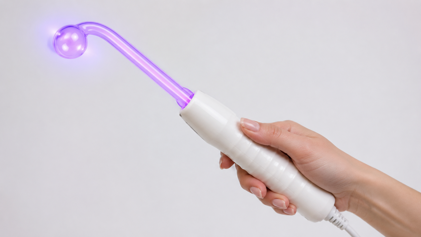 Esthetician holding glass electrode wand close-up